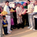 Workers of Mewat (Haryana) giving clothes and fruits to the poors on the birthday of Hon'ble Smt. Sonia Gandhi